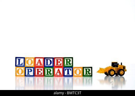 Colorful children's blocks spelling LOADER OPERATOR with a model loader earth moving machine Stock Photo