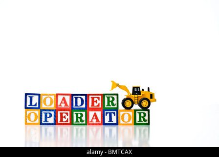 Colorful children's blocks spelling LOADER OPERATOR with a model loader earth moving machine Stock Photo