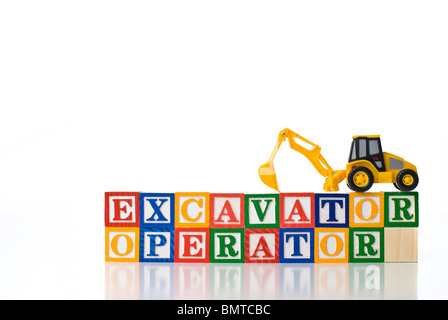 Colorful children's blocks spelling EXCAVATOR OPERATOR with a model backhoe Stock Photo