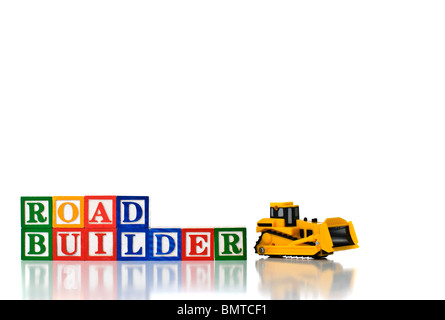 Colorful children's blocks spelling ROAD BUILDER with model bulldozer Stock Photo