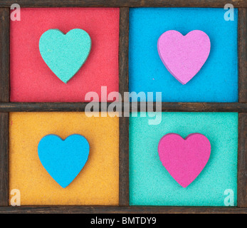 Multicoloured heart shape pattern in a wooden tray Stock Photo