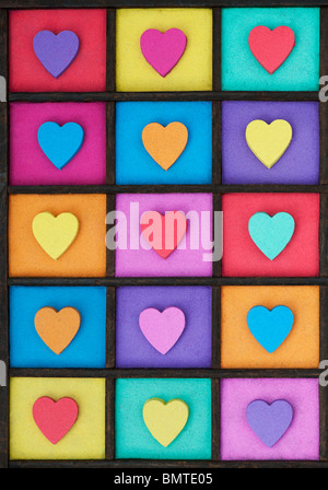Multicoloured heart shape pattern in a wooden tray Stock Photo