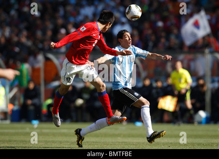 Jung Woo Kim of South Korea (8) heads the ball against Angel Di Maria of Argentina (7) during a 2010 World Cup football match. Stock Photo