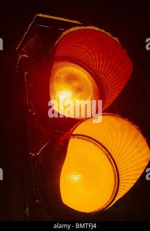 red and amber lights showing on traffic light at night Leeds Yorkshire UK Stock Photo