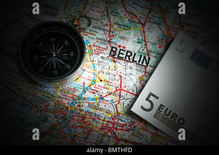 Compass and five euros on a map of Berlin Stock Photo