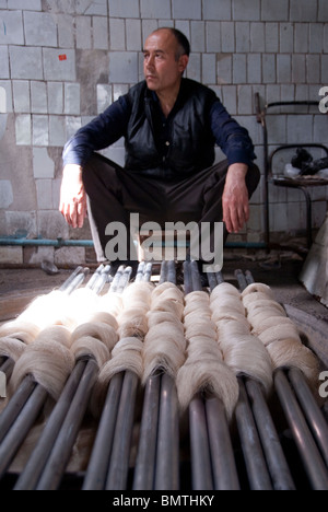 Local man at the Traditional silk factory in Margiland, Uzbekistan. Stock Photo