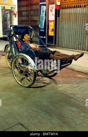 Cyclo drivers relaxing on the street of Phnom Penh- Cambodia Stock Photo