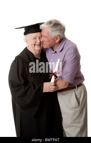 Beautiful Caucasian woman in a black graduation gown with her husband Stock Photo