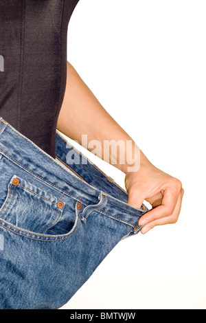 Trying jeans pants after strong diet isolated on white background Stock Photo