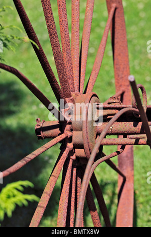 Rusted wheel of antique farm tractor plow Long Island NY Stock Photo