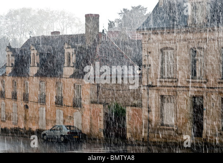 Torrential rainstorm in old town centre - France. Stock Photo