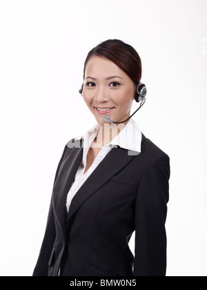 Woman wearing headset, portrait, close-up Stock Photo