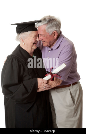 Beautiful Caucasian woman in a black graduation gown with her husband Stock Photo