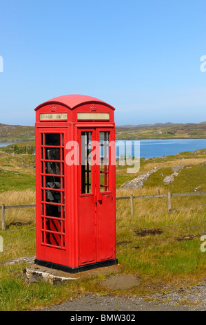 Old style red UK phone box in a rural setting Stock Photo