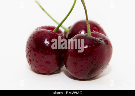 Three sweet cherries isolated on white background Stock Photo
