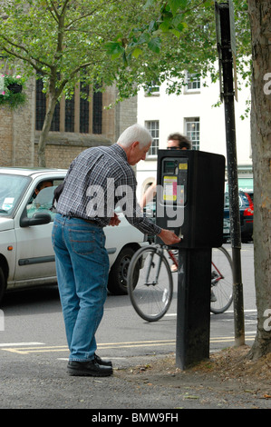 Man at a parking meter Stock Photo