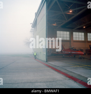 Hangar doors of red Arrows aerobatic team are opened on misty morning. Hangar was HQ for WW2 617 Dambusters Squadron. Stock Photo