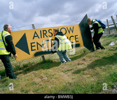 Organisers adjust sign before Caernafon air show by the 'Red Arrows', Britain's Royal Air Force aerobatic team. Stock Photo