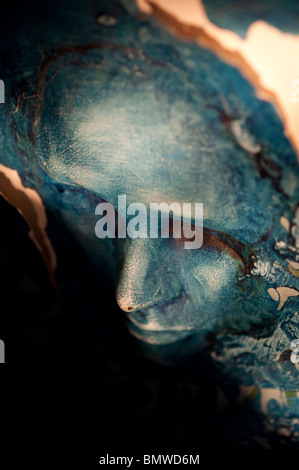 Eerie blue sculpted face close up Stock Photo