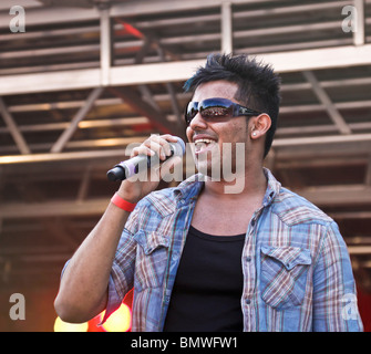 Popular English/British Bhangra singer, Jaz Dhami, at Glasgow Mela 2010 in Kelvingrove Park. Audience reflected in sunglasses. Stock Photo