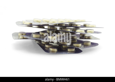 Stack of medicines in blister packs on white background Stock Photo