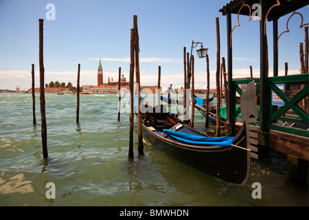 view from St. Mark's Square across the lagoon to the church of San Giorgio Maggiore, anchored gondolas in foreground Stock Photo