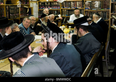 A group of Hasidic men studying the bible in a Yeshiva in Mea Shearim neighborhood in Jerusalem. Stock Photo