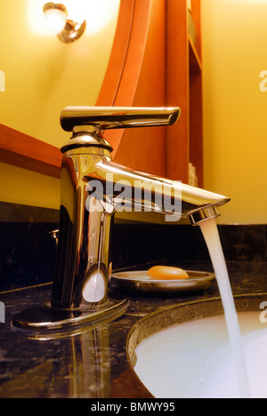 Running water at the bathroom sink Stock Photo