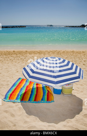 Parasol and towel on a beautiful empty beach Stock Photo