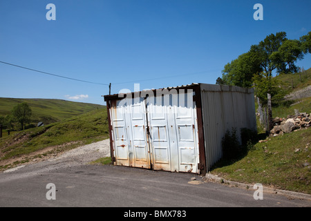 Home made garage shed lockup made of metal on edge of moors Trefil Wales UK Stock Photo