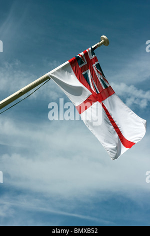 The British Navy white Ensign flying from Brunel's ship the ss Great Britain in Bristol. Shown against a blue sky with clouds. Stock Photo