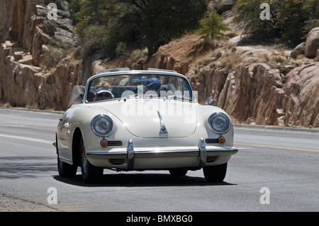 A 1965 Porsche 356C Cabriolet, being driven on a road in the western US. Stock Photo