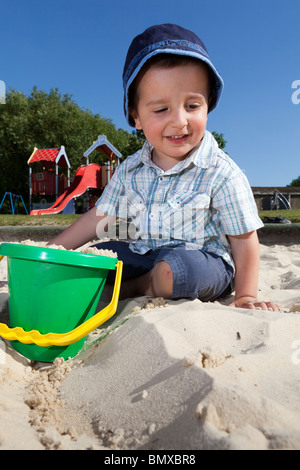 Child playing in the sand pit Stock Photo