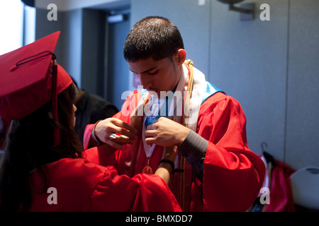 Hispanic boy prepares for his high school graduation ceremony at KIPP Academy in Houston, Texas, USA Stock Photo