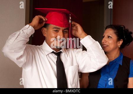 Hispanic teen boy prepares for his high school graduation ceremony at KIPP Academy in Houston, Texas, USA Stock Photo