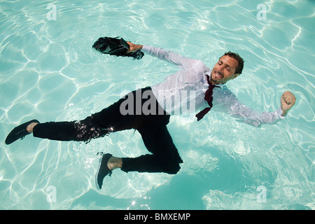 Businessman in swimming pool Stock Photo