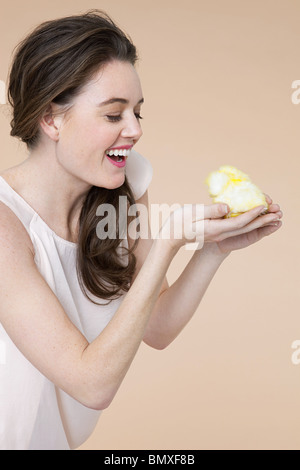 Young woman with easter chick Stock Photo