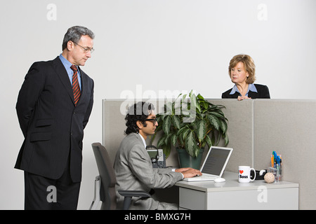 Businessman watching over work Stock Photo