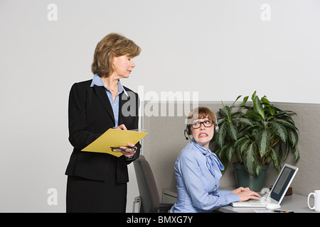 Businesswoman watching over work Stock Photo