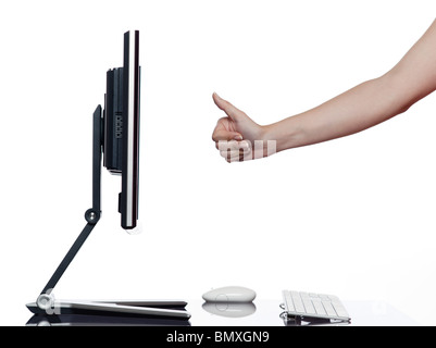 communication between human hand and a computer display monitor on isolated white background expressing success thumb up concept Stock Photo