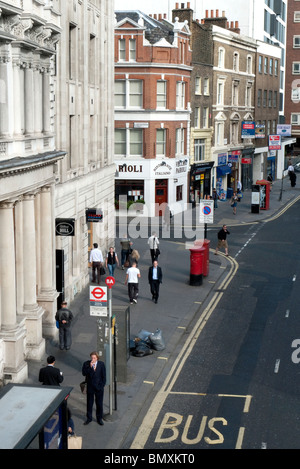 Man waiting at a bus stop viewed from above Aldersgate City of London, England UK Stock Photo