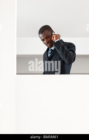 young adult afro-american businessman talking on the phone indoors. Copy space Stock Photo