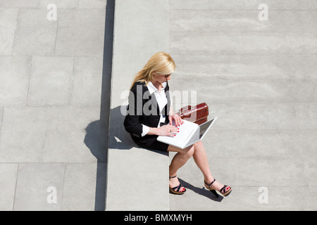 high angle view of businesswoman using computer laptop outdoors Stock Photo