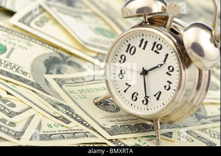 Time - money. Business concept. Analog hours on a heap of paper dollars Stock Photo