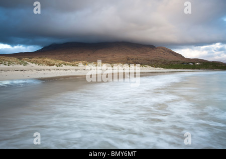 Waves breaking on a remote Irish beach in the West of Ireland, overlooked by Mweelrea mountain Stock Photo