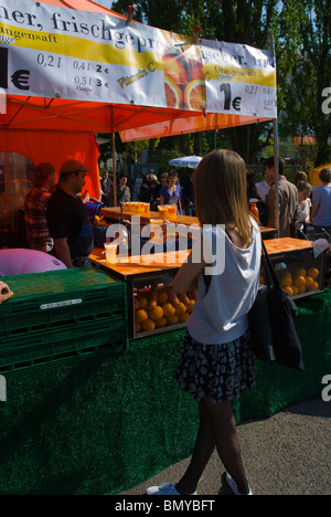 Freshly pressed orange juice stand Mauerpark flea market Mitte central Berlin Germany Stock Photo