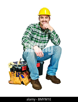 young handyman sit on his toolbox isolated on white Stock Photo