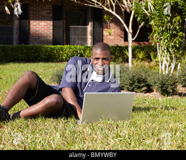 Black man typing on laptop Stock Photo