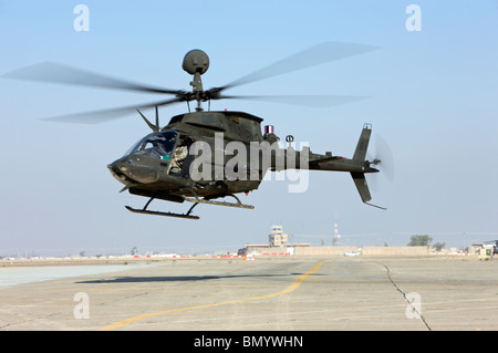 An OH-58D Kiowa Warrior hovers over the flight line at Camp Speicher, Iraq. Stock Photo