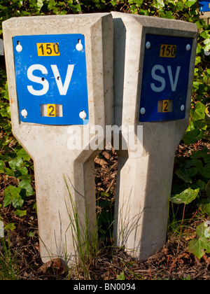 Sluice Valve markers used to indicate the position of underground valves used to regulate water in pipes photographed in the UK Stock Photo